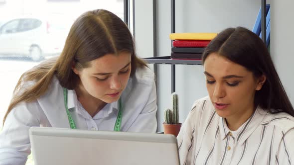 Two Young Businesswomen Working on a Computer Together