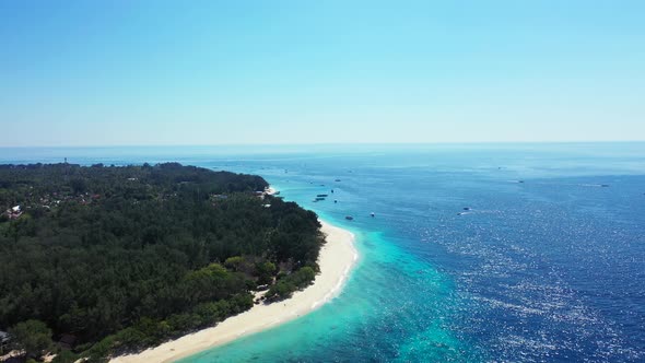 Natural fly over clean view of a white sandy paradise beach and aqua blue ocean background in 4K