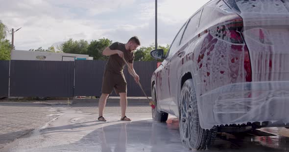 Man Washes Car at Selfservice Car Wash