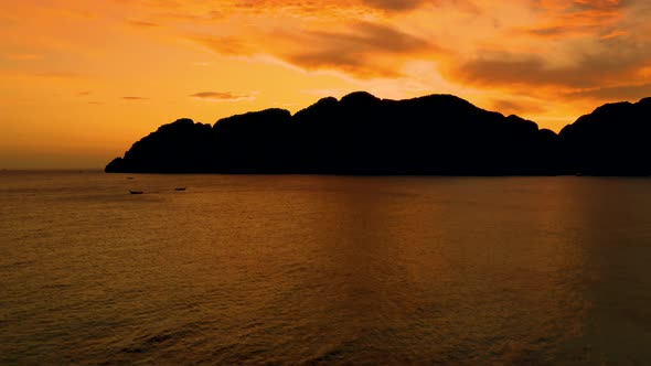 Amazing colorful sunset behind an island. Ko Phi Phi Thailand at dusk. Aerial