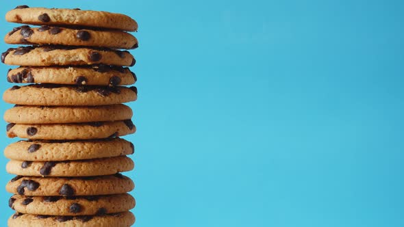 A Stack Chocolate Chip Cookies Rotate on a Blue Background