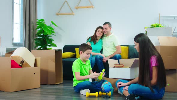 In a Modern New Home Mature Parents Take a Sit on