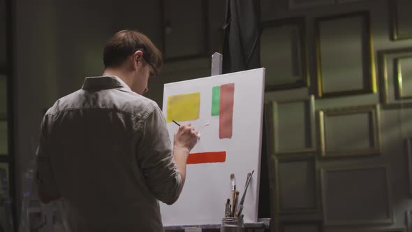 Male Artist Painting Geometric Shapes