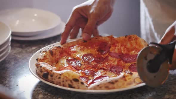 Freshly Pizza of Slicing a Pepperoni Pizza Into Multiple Slices With a Pizza Cutter.