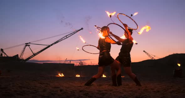 Professional Artists Show a Fire Show at a Summer Festival on the Sand in Slow Motion