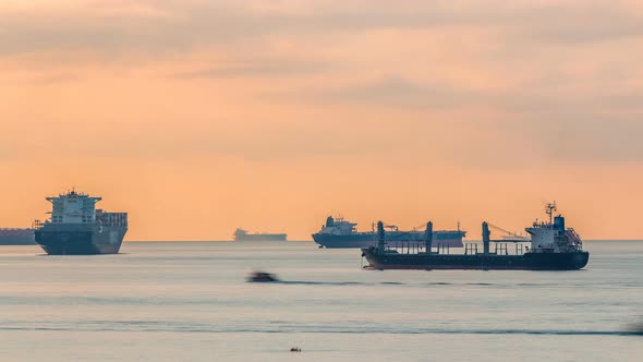 Early Morning Scene of Cargo Ships and Tankers Anchored Off of Singapore's Coast Timelapse