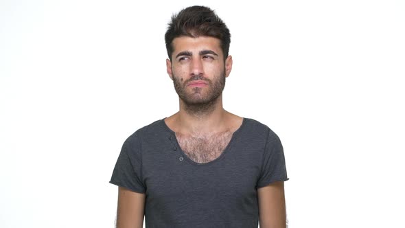 Slomo Young Skeptical Man Wearing Grey Tshirt Looking at Camera Expressing Misunderstanding Throwing