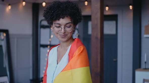 Black Girl Wears Lgbt Flag on Her Shoulders Looking at the Camera Smiling