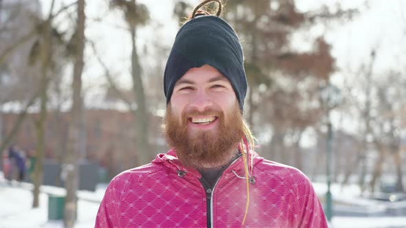 Bearded Man Laughing at Camera in Winter Park