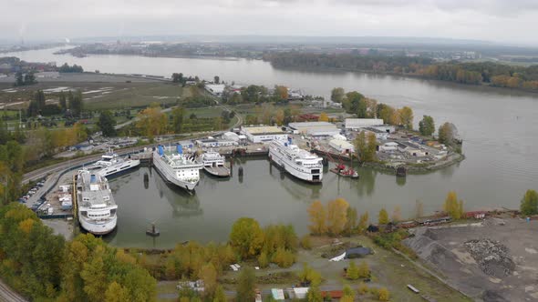 Huge Transport Ferries In A Repair Dock By The Fraser River In British Columbia - aerial shot