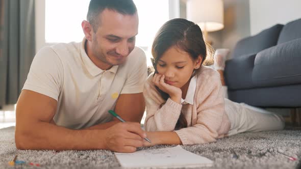 Father and Daughter Communicate, Having Fun and Painting Together. Concept of a Happy Family and