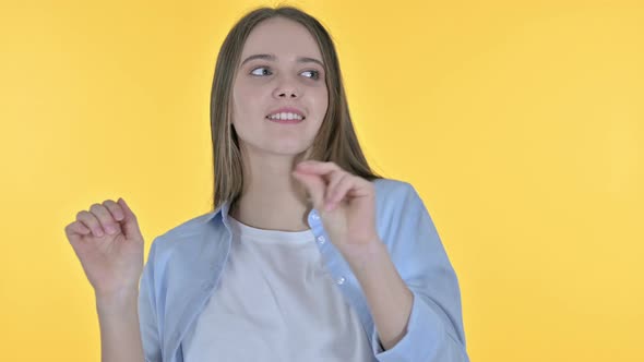 Happy Beautiful Woman Dancing To Music, Yellow Background