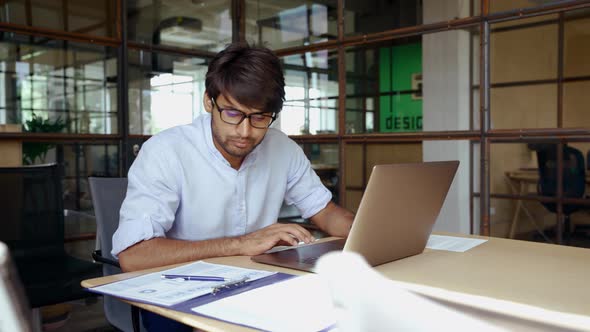 Young Indian Business Man Using Laptop Computer Working in Office