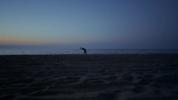 Silhouette Woman Making Yoga on Beach Late Evening