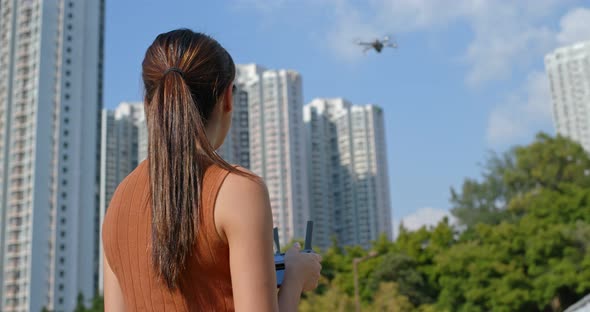 Woman play flying drone at outdoor