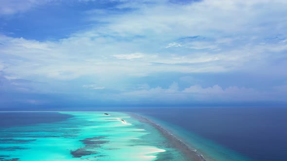 Wide drone copy space shot of a sunshine white sandy paradise beach and blue sea background