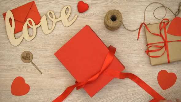 Hands Unpacking Valentines Giftbox With Heart-Shaped Chocolate Candies, Surprise