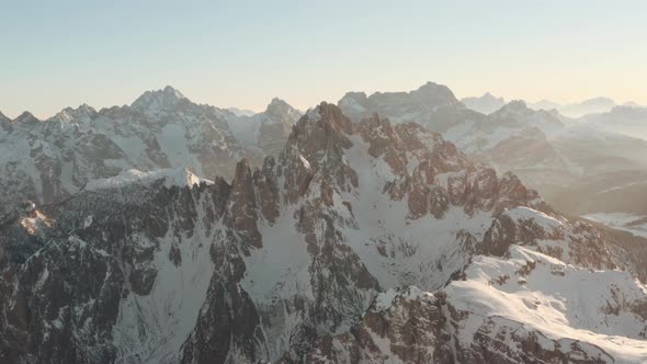 Circling drone shot of Cadini group mountains at sunset