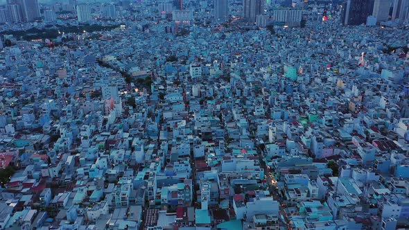 drone shot panning from left to right at twilight over densely populated and built up area of a mode