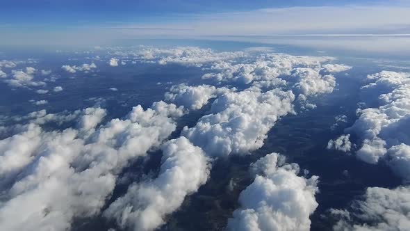 Flying over islands of beautiful clouds over a mountain landscape -Aerial