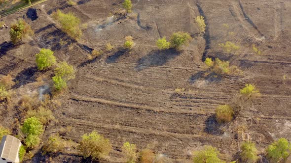 Aerial view of dry grass field in fire