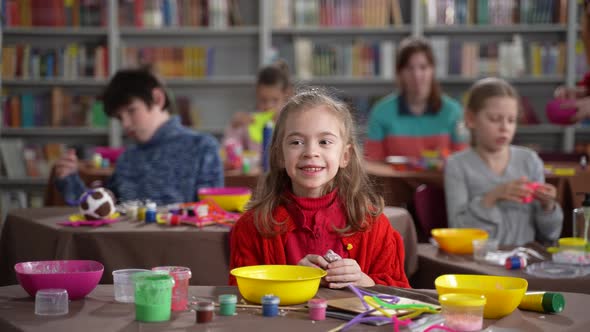 Smiling Autistic Girl with Slime Posing on Camera