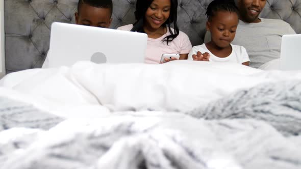 Family using electronic devices in bedroom 4k