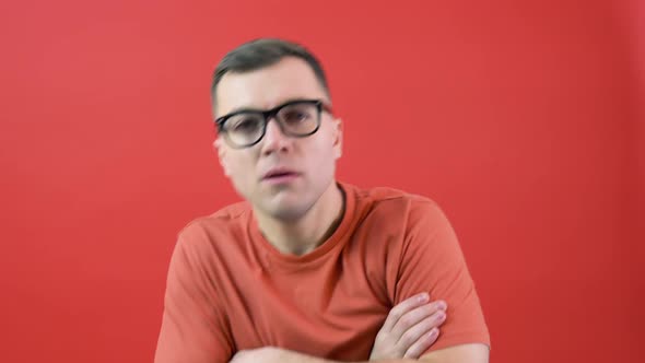 A Man in Glasses Looks Into the Camera As If He Can't See Well