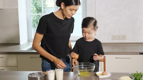 Woman and Little Girl Cooking in the Kitchen