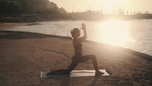 Silhouette of Woman Doing Stretching at Early Morning in Ray of Sun Slow Motion