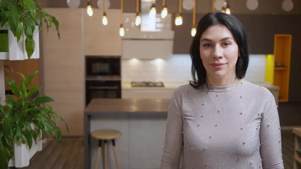 Portrait of Confident Caucasian Woman Posing in Furniture Store As Girl Choosing New Kitchen at