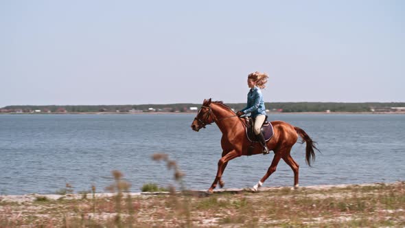 Woman Galloping by Lake on Horseback