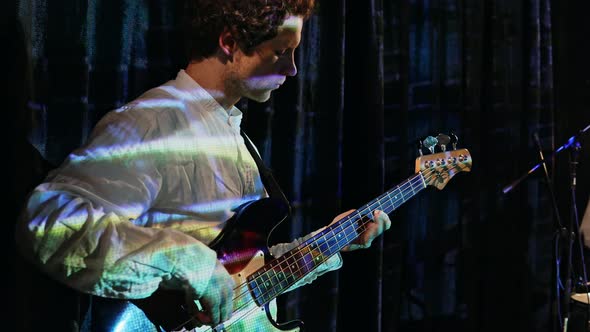 Young Bass Player Playing Guitar in a Nightclub