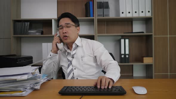 Businessman office worker typing at the laptop computer and many work