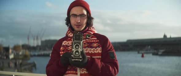 Young man with glasses giving directions looking into the camera