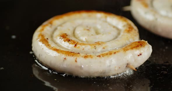 Fried Sausage in Hot Oil and with Steam. 