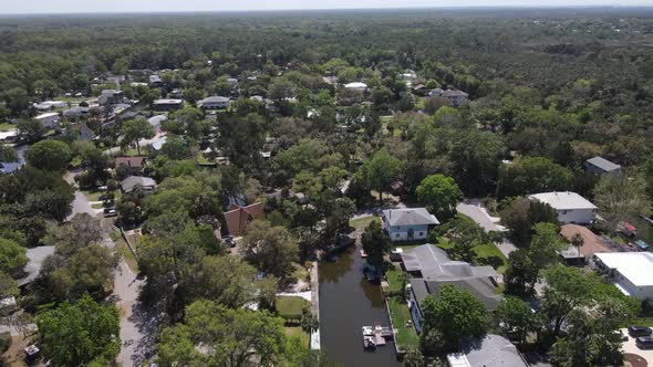 slow aerial turn over a forested, secluded canal-lined neighborhood in Weeki Wachee, Florida