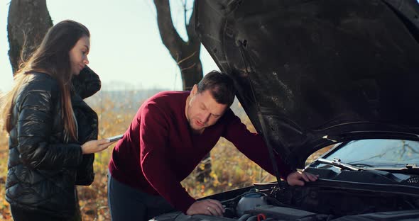 Couple on the Road Having Problem with a Car