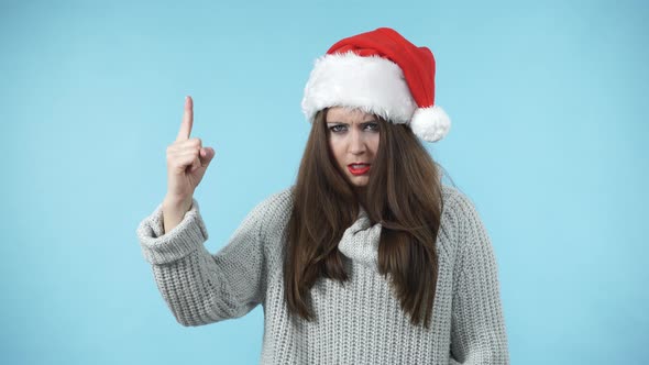 Woman In Santa Hat Say No By Shaking Finger
