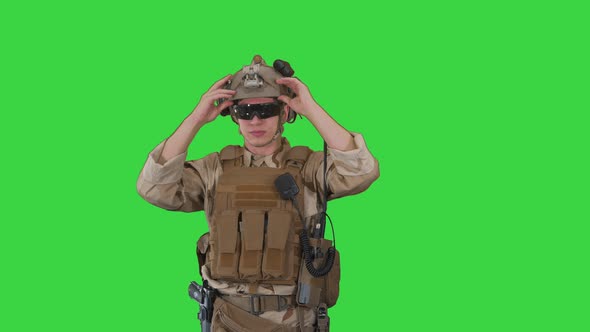 Soldier Preparing Tactical Gear for Action Battle on a Green Screen Chroma Key