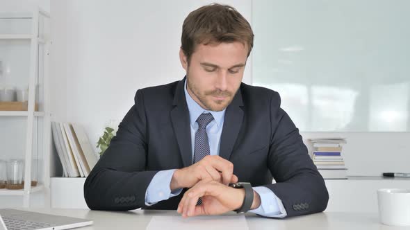 Businessman Using Smartwatch Online Browsing