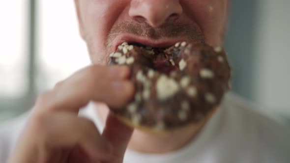 Man Eating Sweet Chocolate Donut