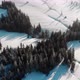 Drone View of Snowy Valley in Mountains with Trees in Haze and Bright Sunlight - VideoHive Item for Sale