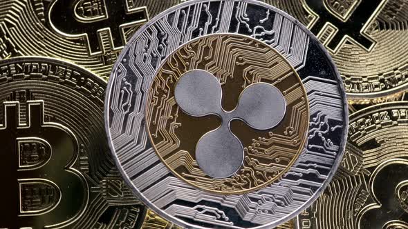 Ripple XRP coin on bitcoins background, cryptocurrency investing concept.