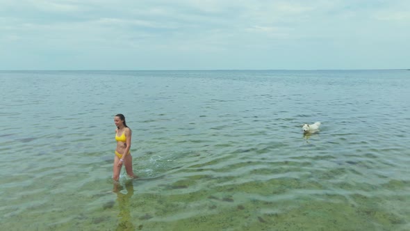 Slow Motion Drone Footage Woman in Yellow Bikini Going Into the Sea