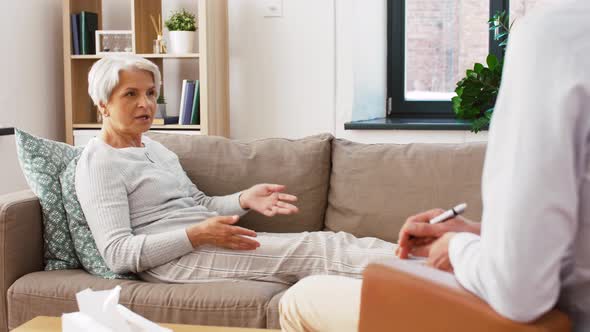 Senior Woman Patient Talking To Man Psychologist