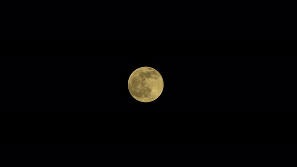 Full moon in the dark night sky in summer with no clouds