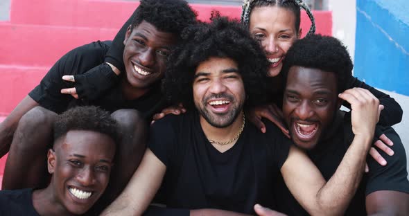 Group of young multiracial people smiling on camera outdoor