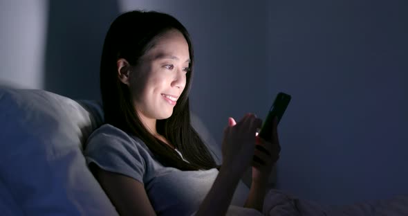 Woman Use of Smart Phone on Bed at Night