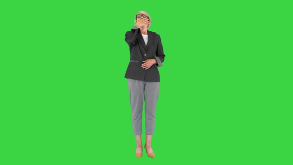 Tired Bored Attractive Senior Woman Yawning on a Green Screen Chroma Key